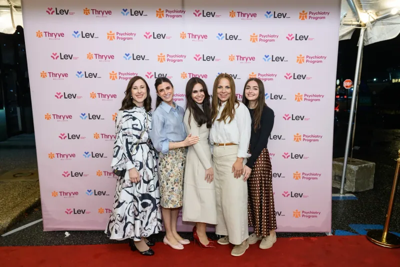 A group photo at the Thryve and Lev backdrop in Monsey.
