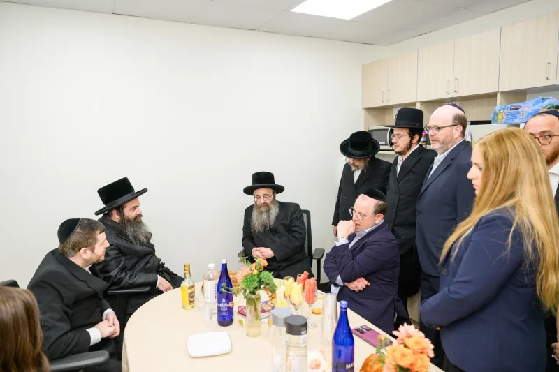 A conversation around a table during the Monsey opening.
