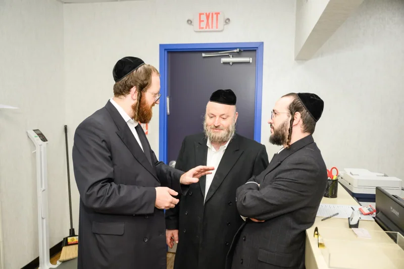 Guests in conversation inside the Monsey program space.