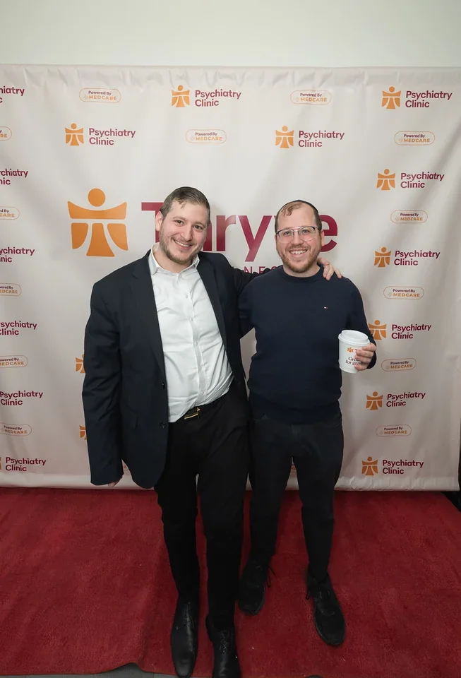Two guests stand together at the Thryve Williamsburg opening.