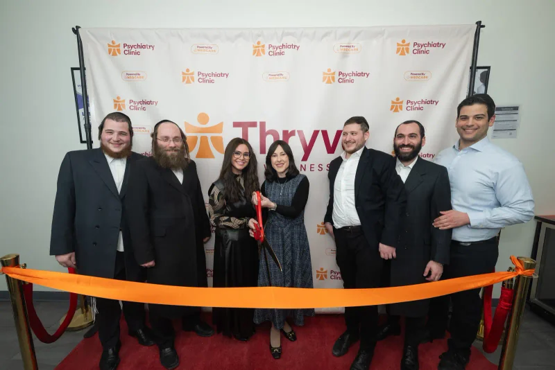 Thryve and program leaders standing together behind the ribbon