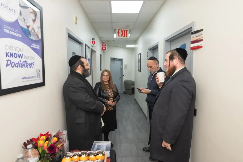 Community partners speaking in the hallway during the opening
