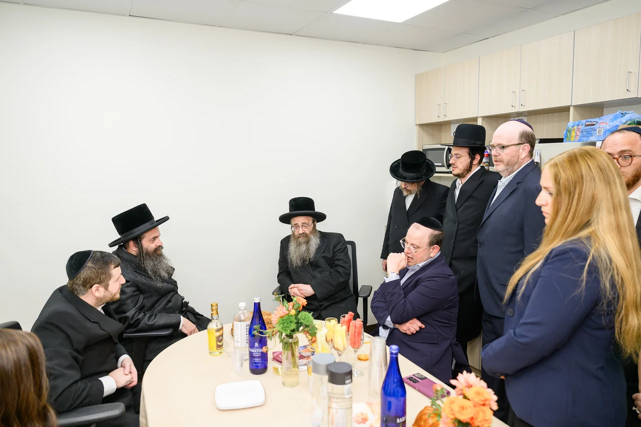 A conversation around a table during the Monsey opening.