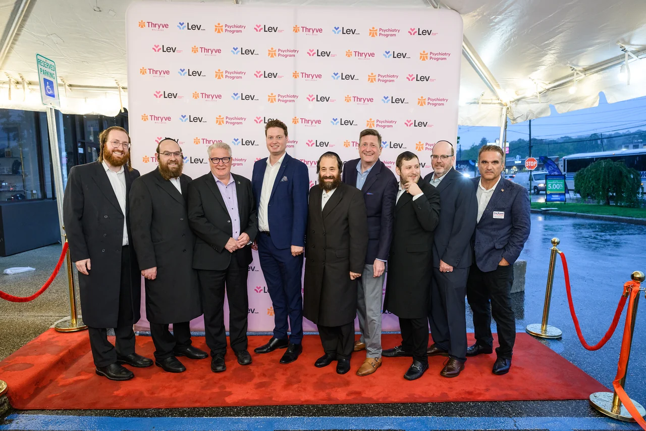 A group photo at the Thryve and Lev Health Center backdrop.