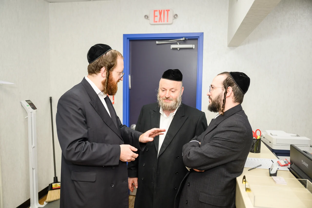 Guests in conversation inside the Monsey program space.