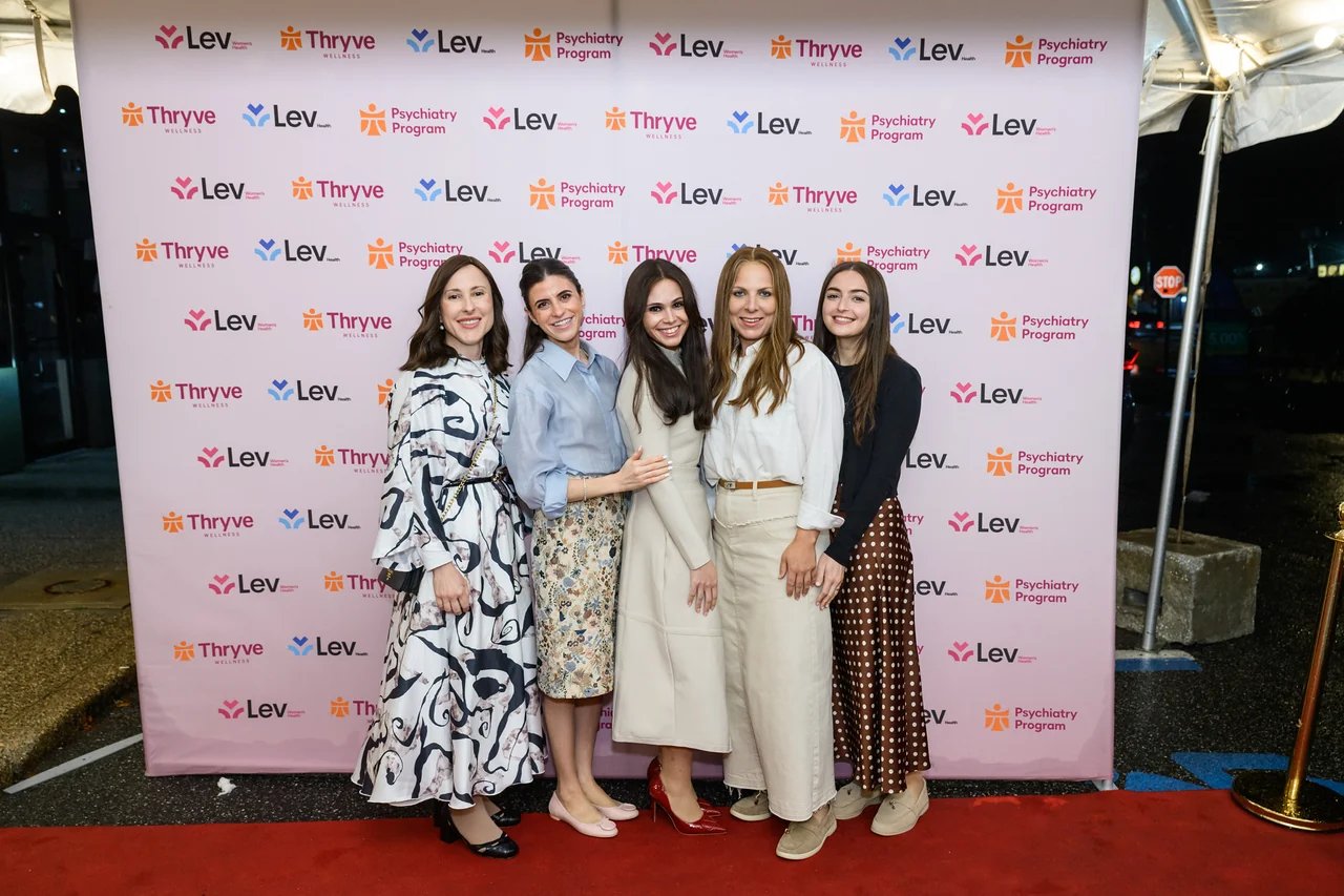 A group photo at the Thryve and Lev backdrop in Monsey.