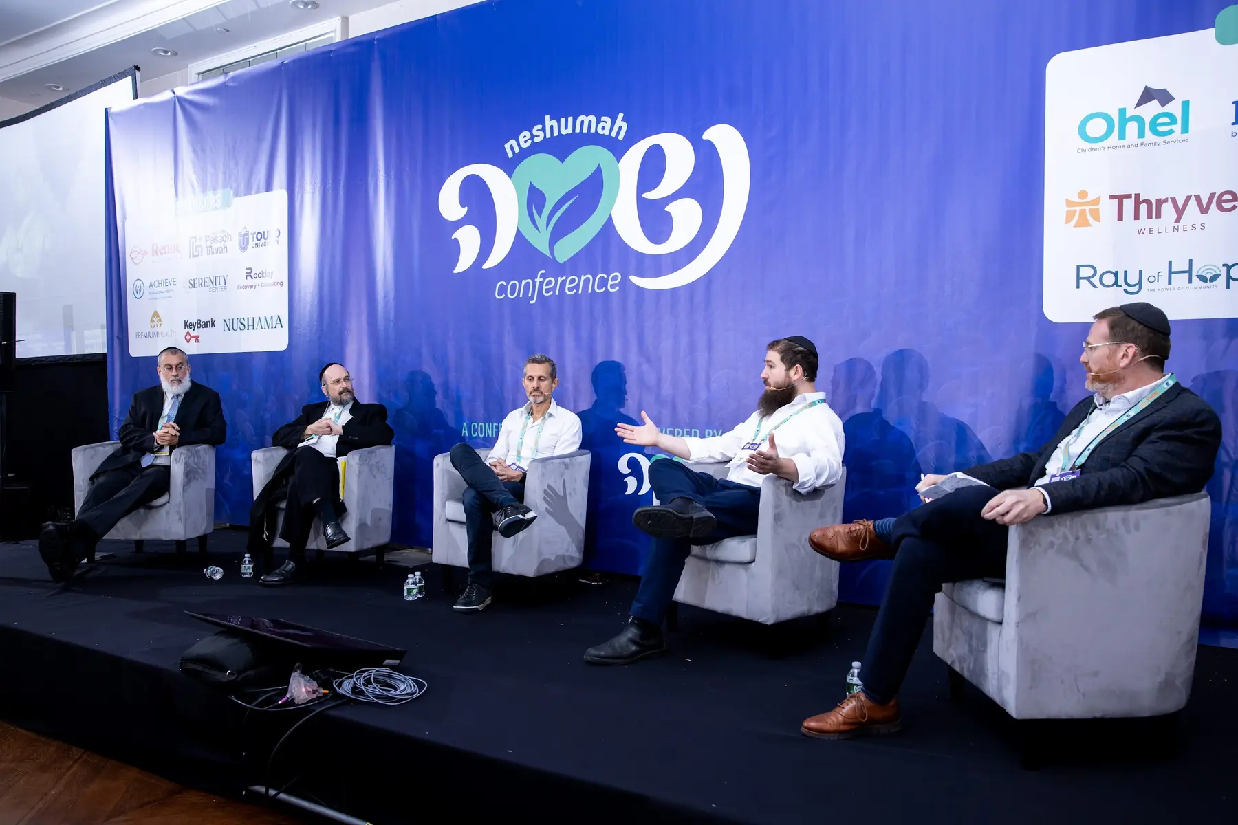 A panel discussion at Neshumah 2025 with Thryve among the conference partners
