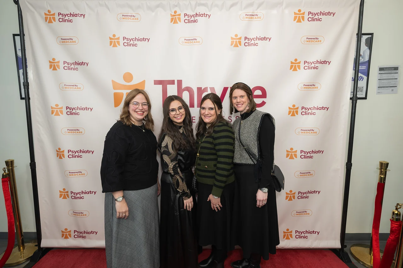 A group photo beside the Thryve backdrop in Williamsburg.